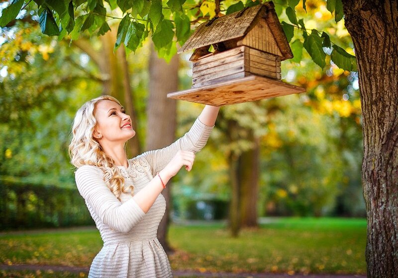Woman Hanging Birdhouse