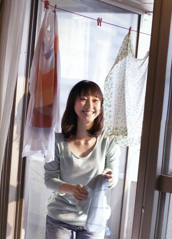 woman hanging laundry in sunlight