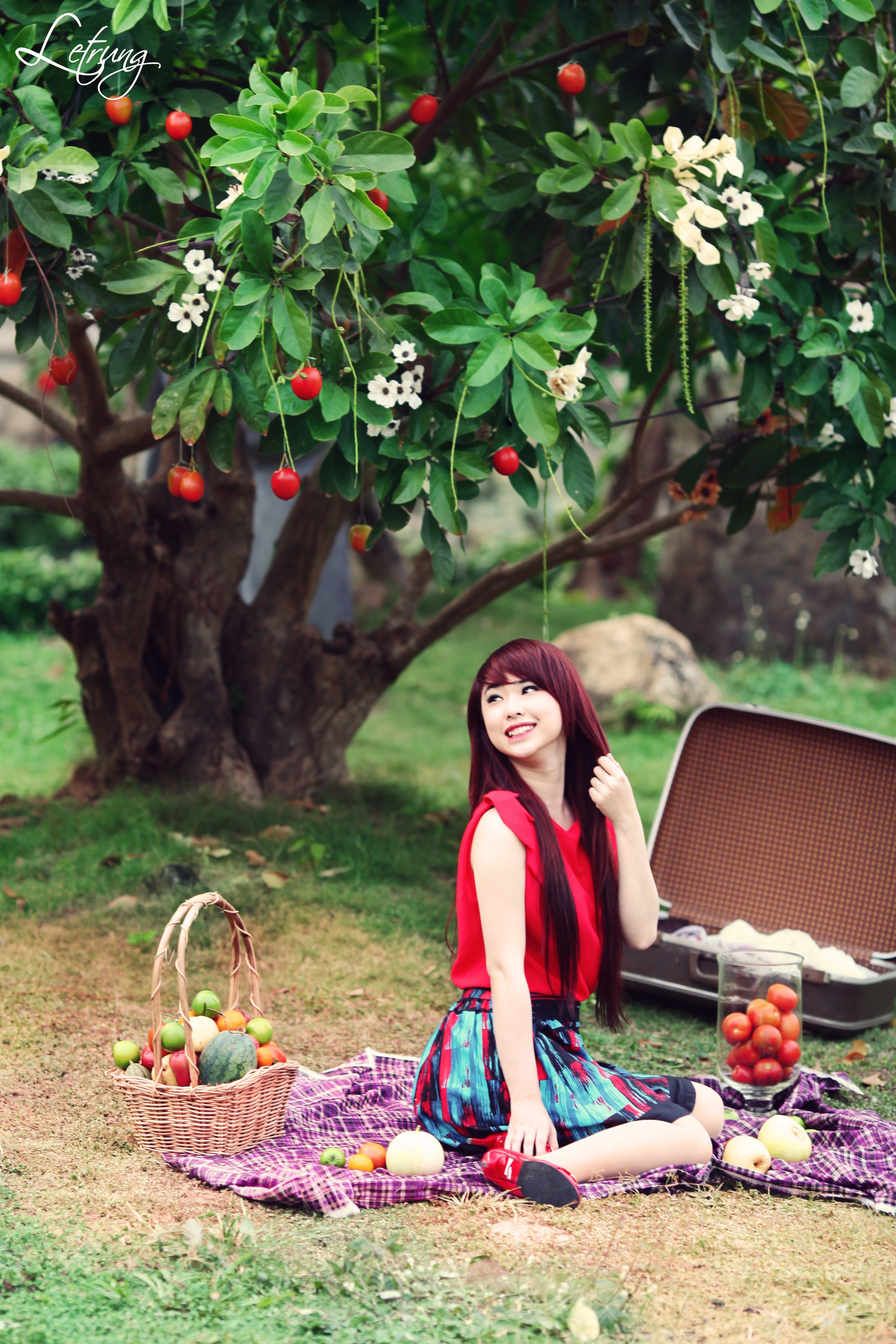 Woman having picnic under tree