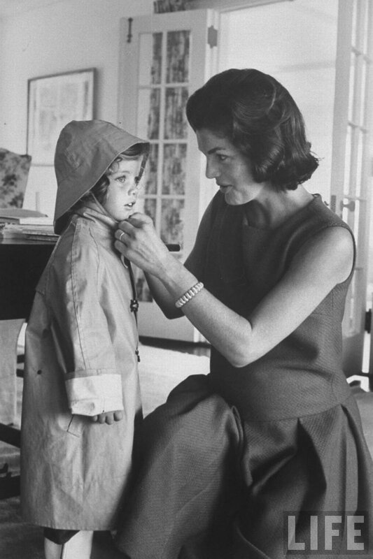woman helping child with coat