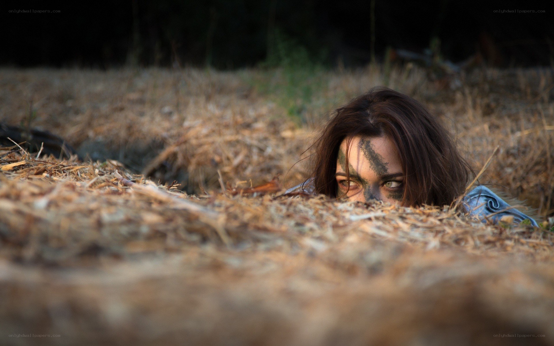 woman hiding in hay