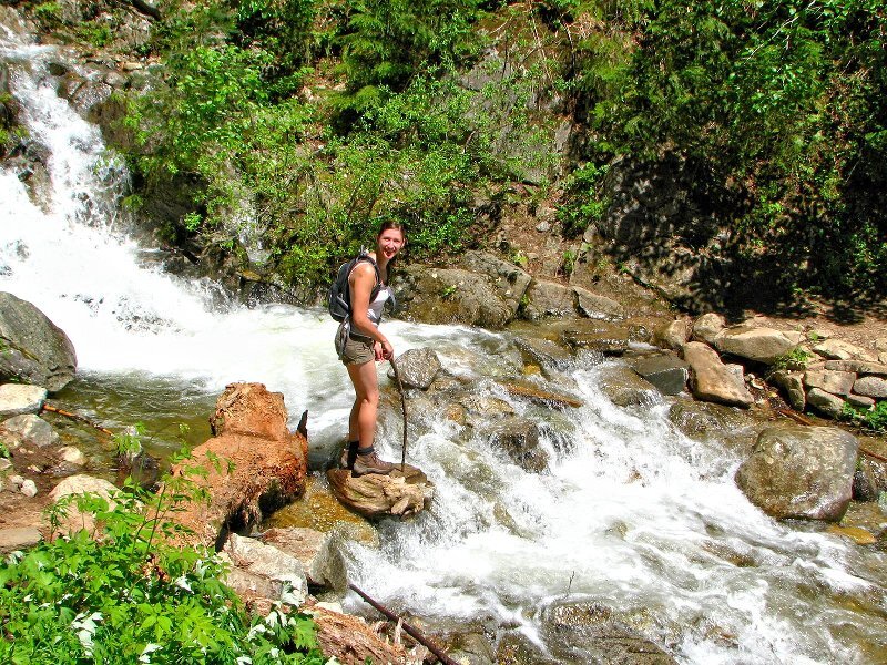 Woman Hiking by Stream