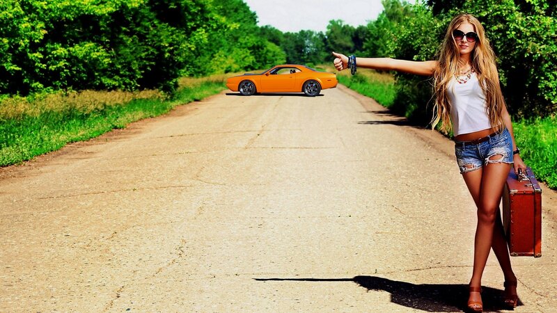 woman hitchhiking on country road