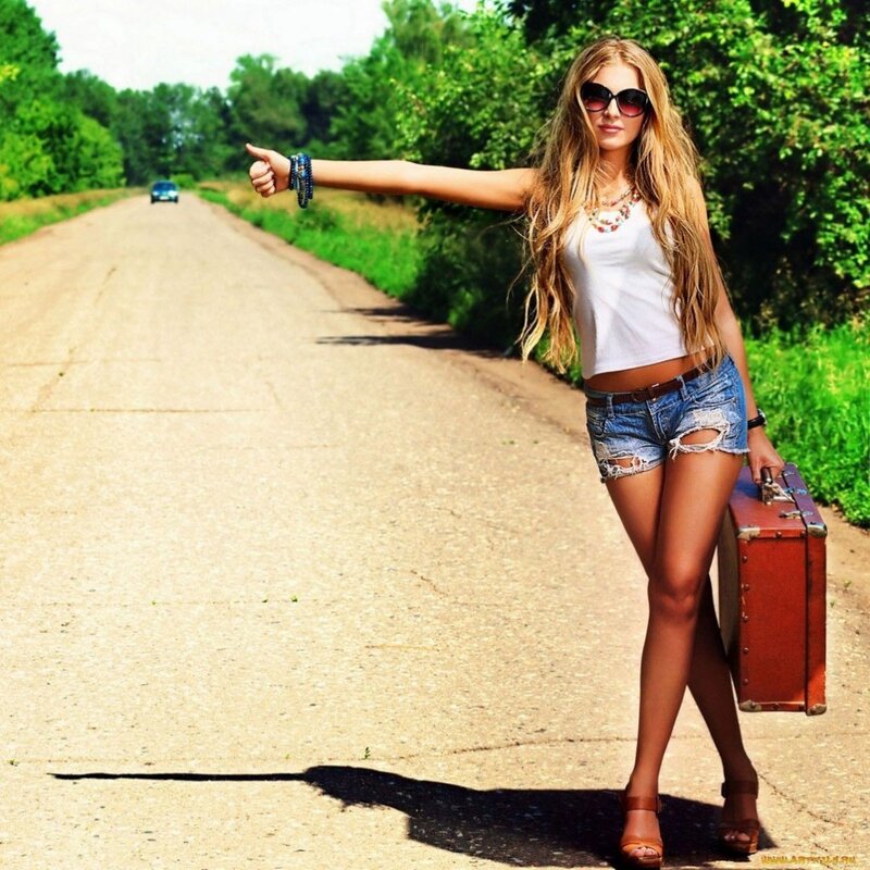 woman hitchhiking on country road