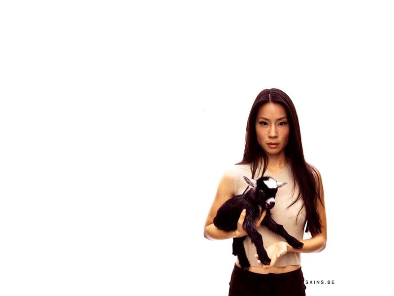 woman holding a baby goat
