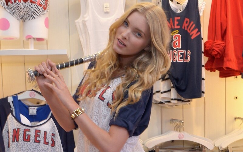 Woman holding a bat in a store