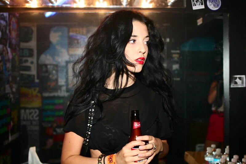 Woman holding a beer in a club