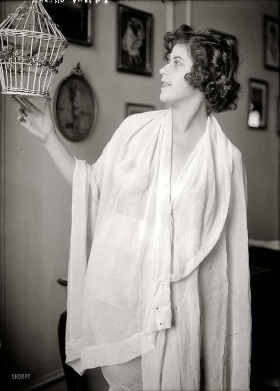 Woman holding a birdcage