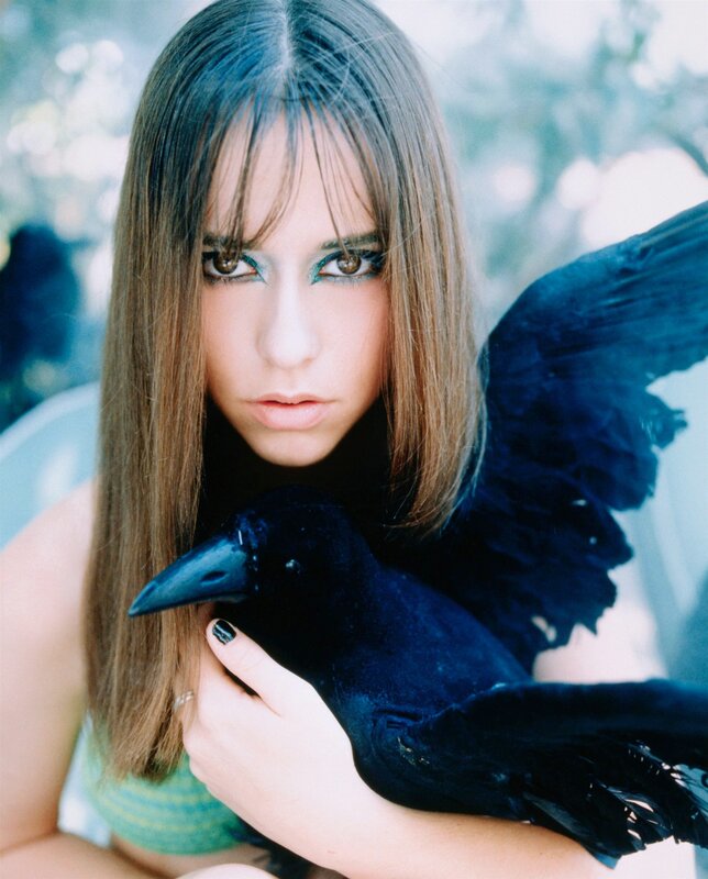 woman holding a black bird