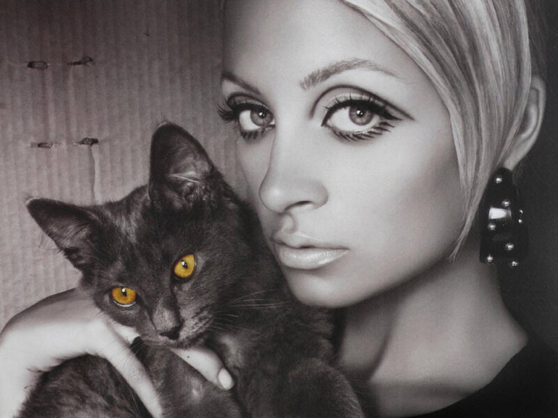 woman holding a black cat