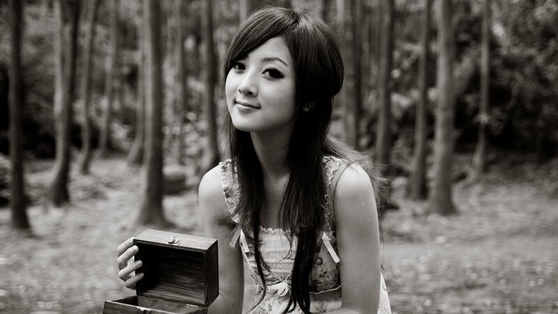 woman holding a box in the woods