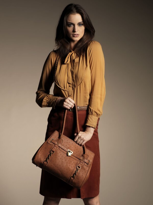 woman holding a brown handbag
