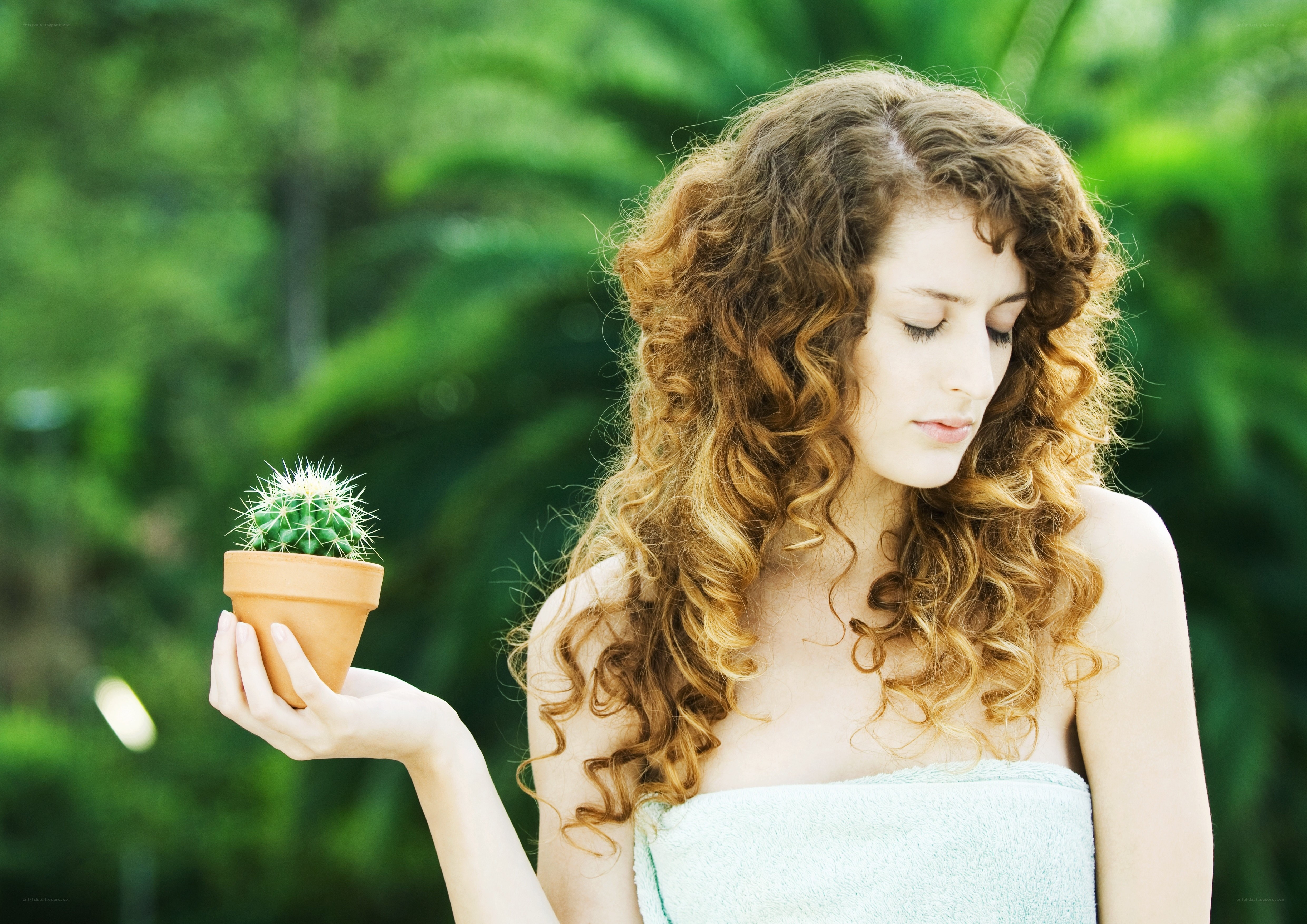 woman holding a cactus