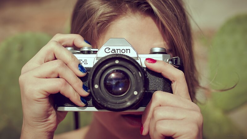 woman holding a canon camera