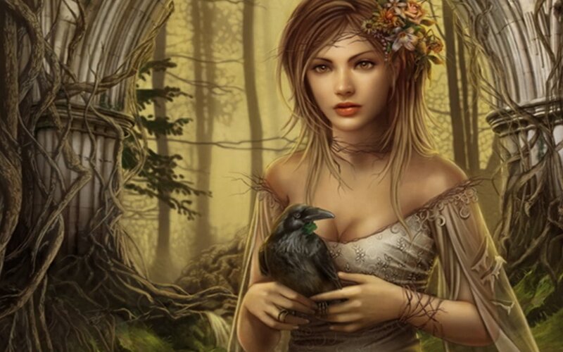 woman holding a crow in forest