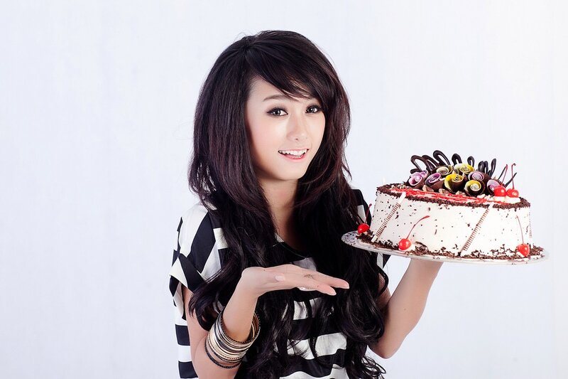 Woman holding a decorated cake