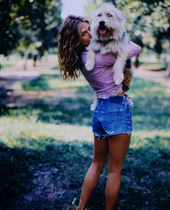 Woman holding a dog outdoors