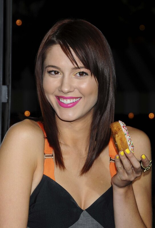 woman holding a donut