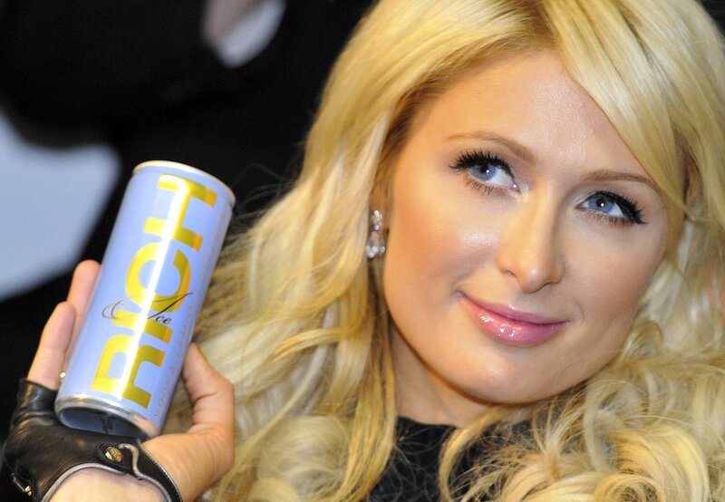 woman holding a drink can