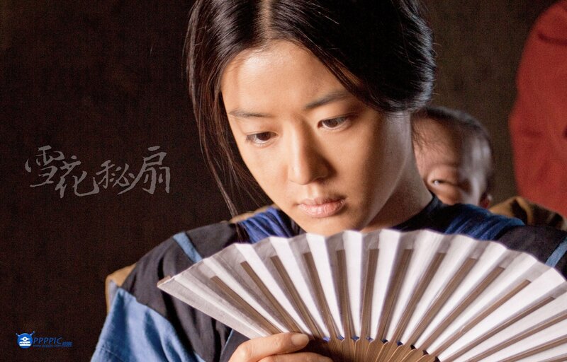 woman holding a fan