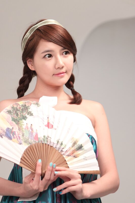woman holding a fan