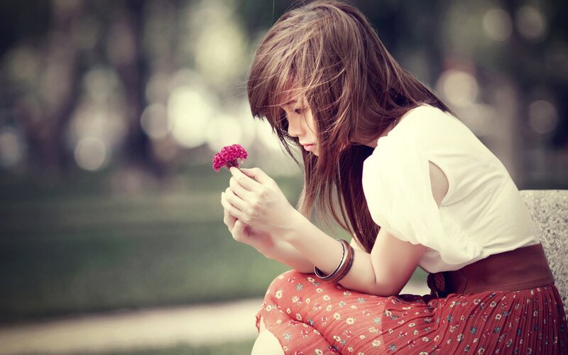 woman holding a flower