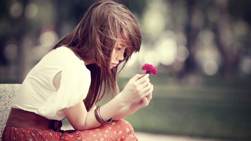 woman holding a flower