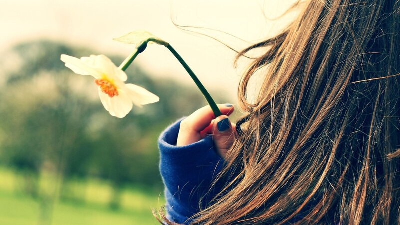 woman holding a flower