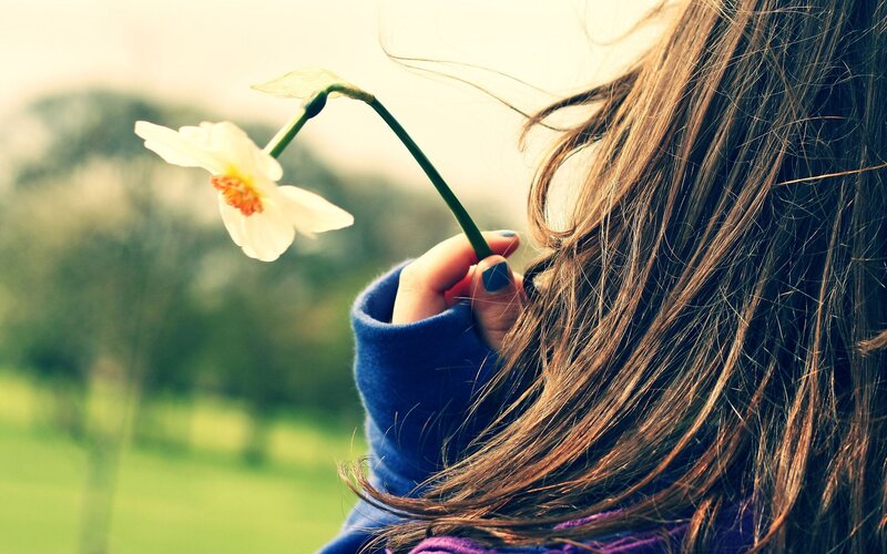 woman holding a flower