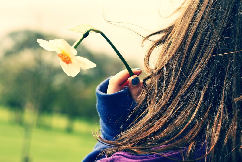 woman holding a flower
