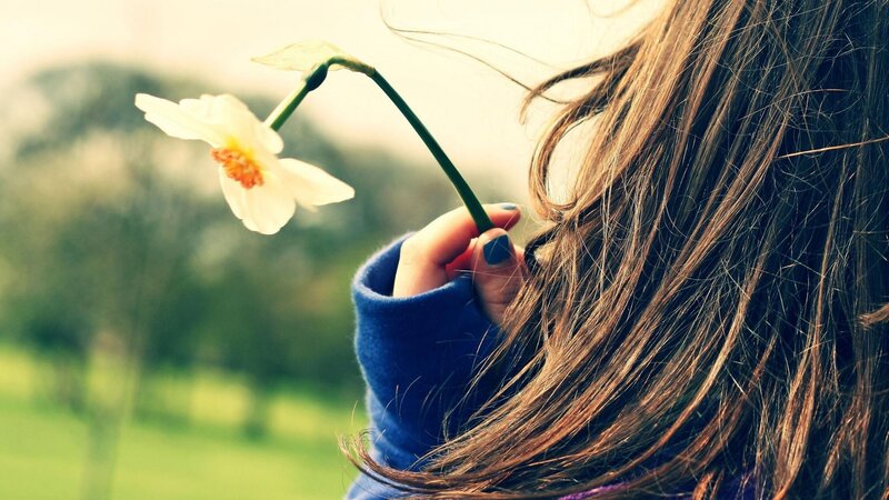 woman holding a flower