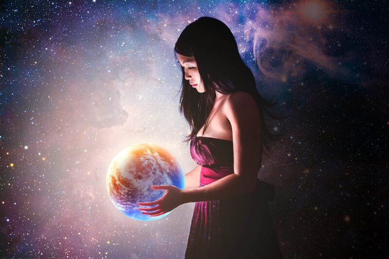 woman holding a glowing planet