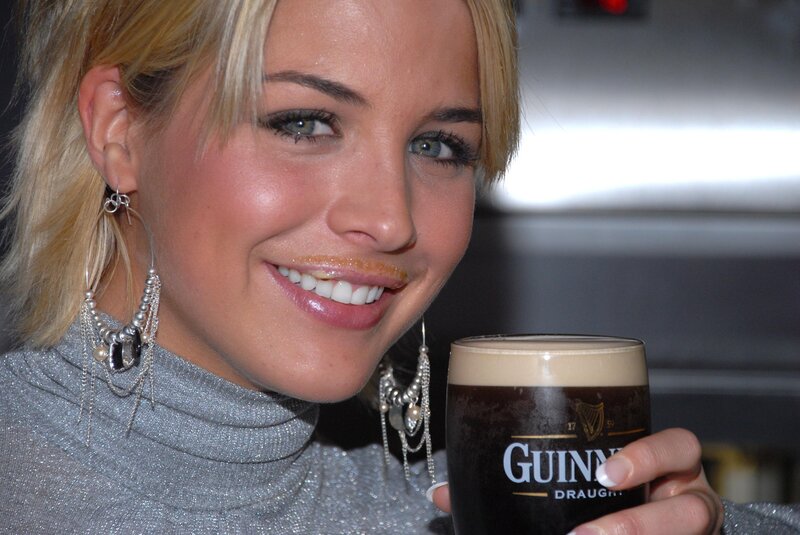 Woman holding a Guinness beer