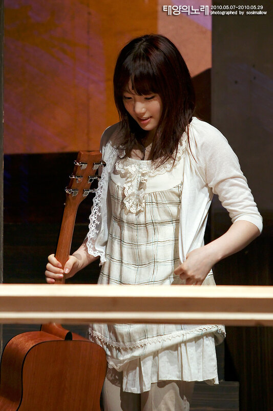 woman holding a guitar