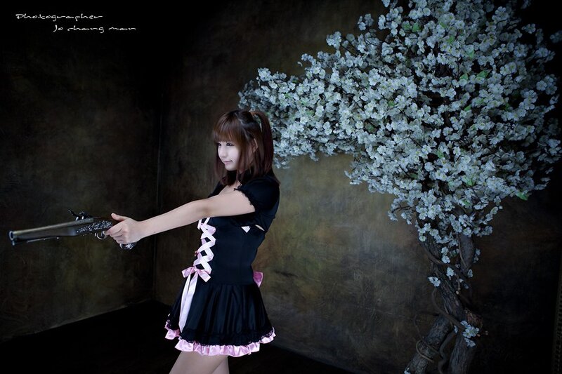 Woman Holding a Gun — Black, Dramatic, Photograph, Flowering Tree