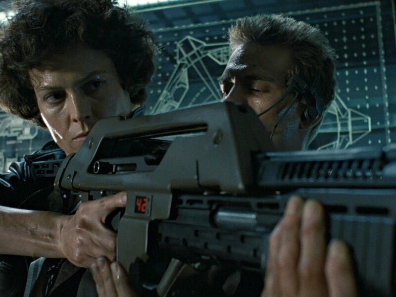 Woman Holding a Gun — Gray, Tense