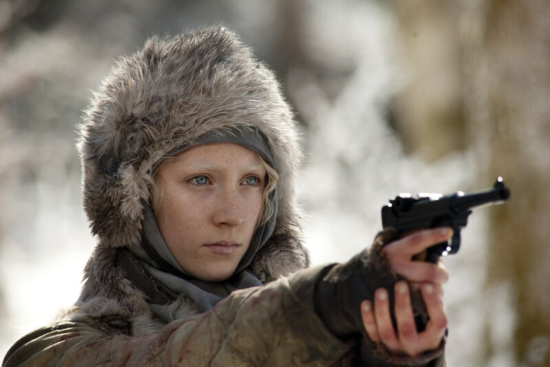 woman holding a gun in winter