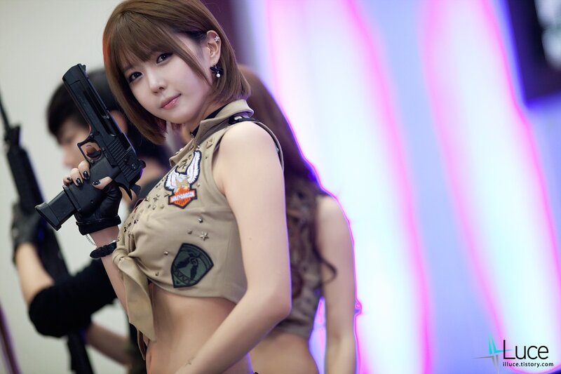 Woman Holding a Gun — Tan
