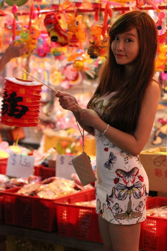 Woman holding a lantern at a market