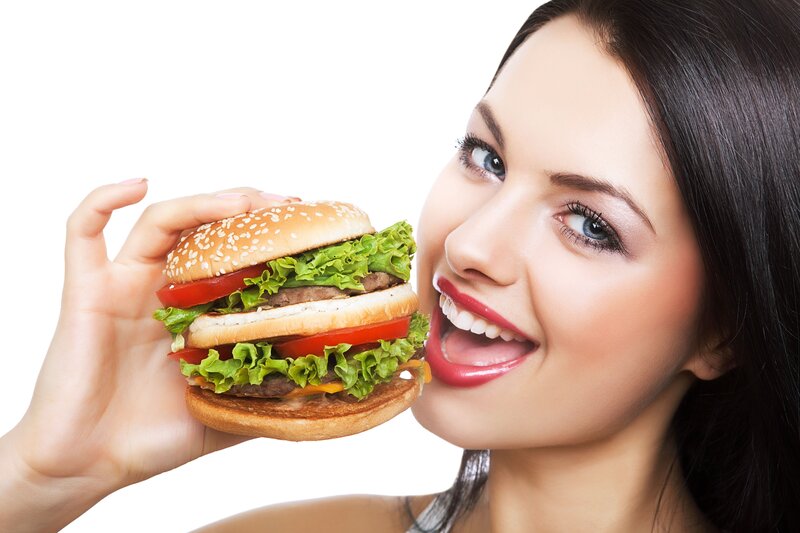 woman holding a large burger