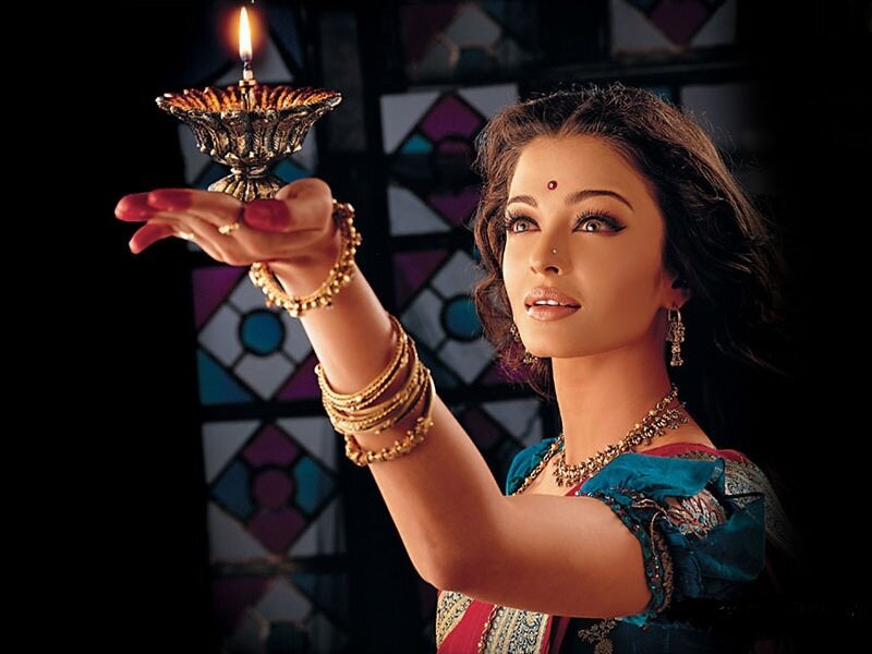 woman holding a lit oil lamp