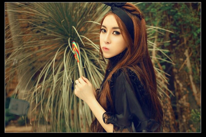 woman holding a lollipop