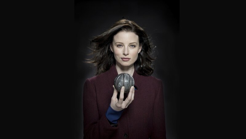 Woman holding a metallic sphere