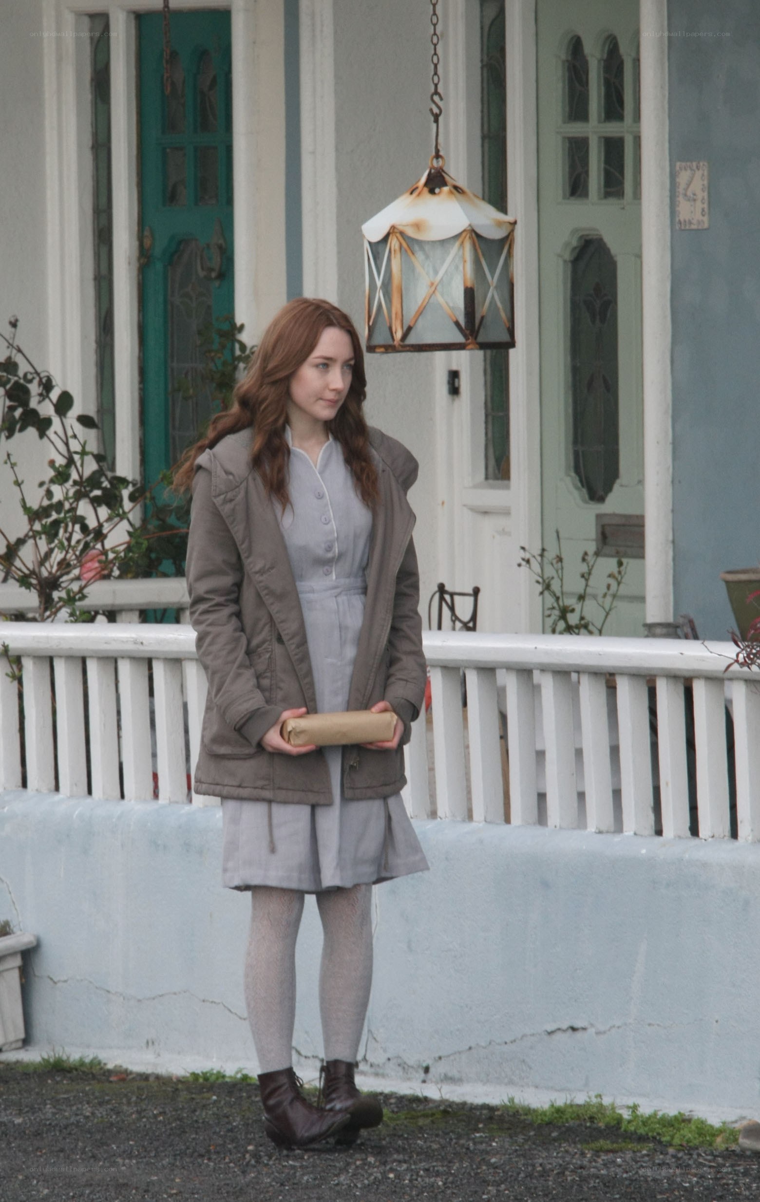 woman holding a package outside