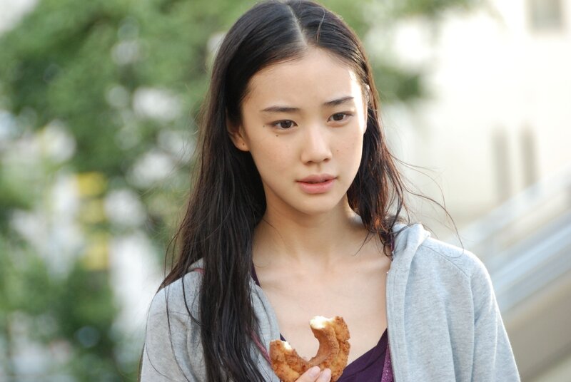 woman holding a pastry