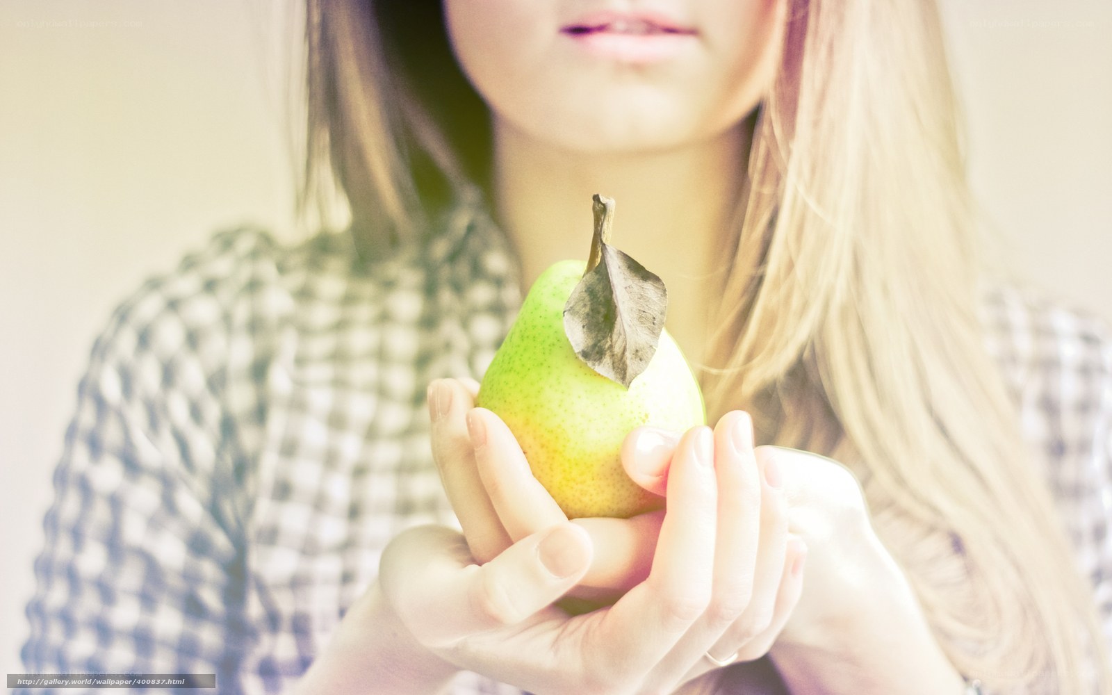 woman holding a pear