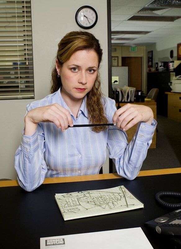 woman holding a pencil at desk