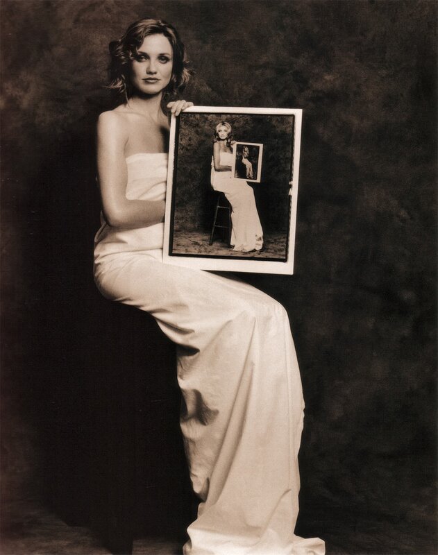 Woman holding a photo of herself