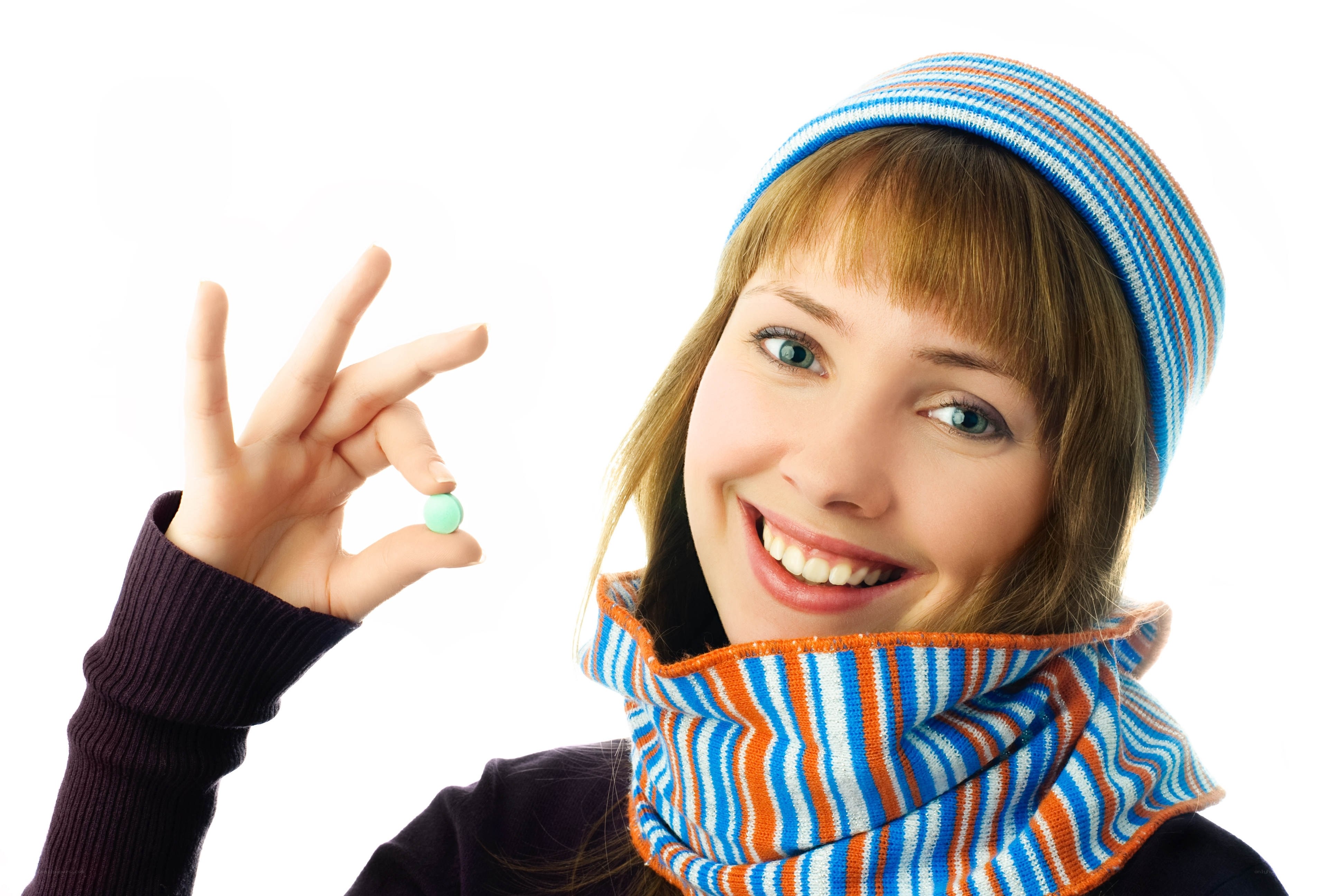 woman holding a pill