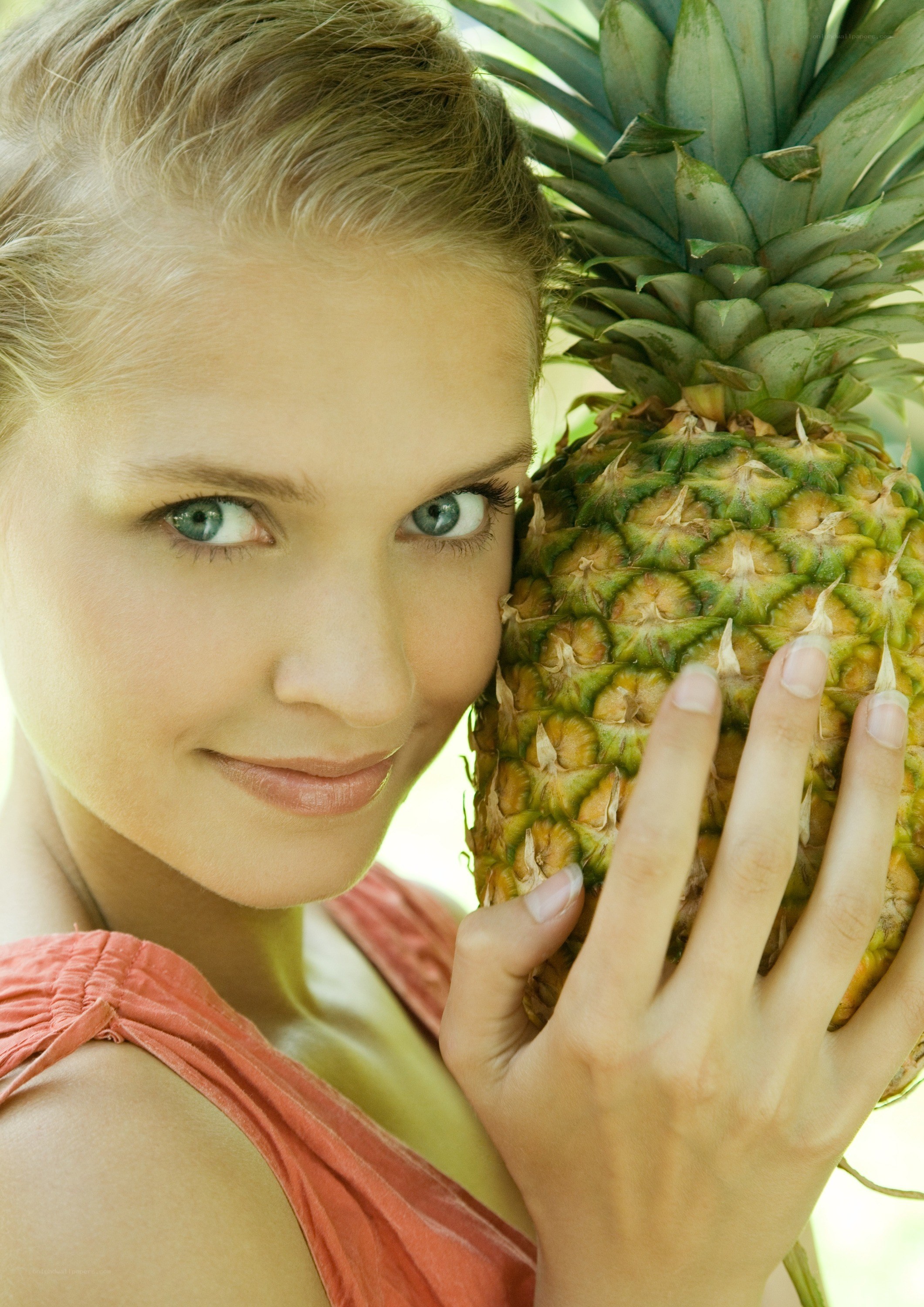 woman holding a pineapple